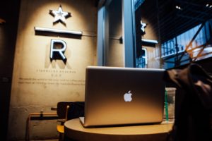 Mac Laptop on table in oddly lit venue