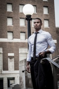 african american man in shirt and tie by street lamp