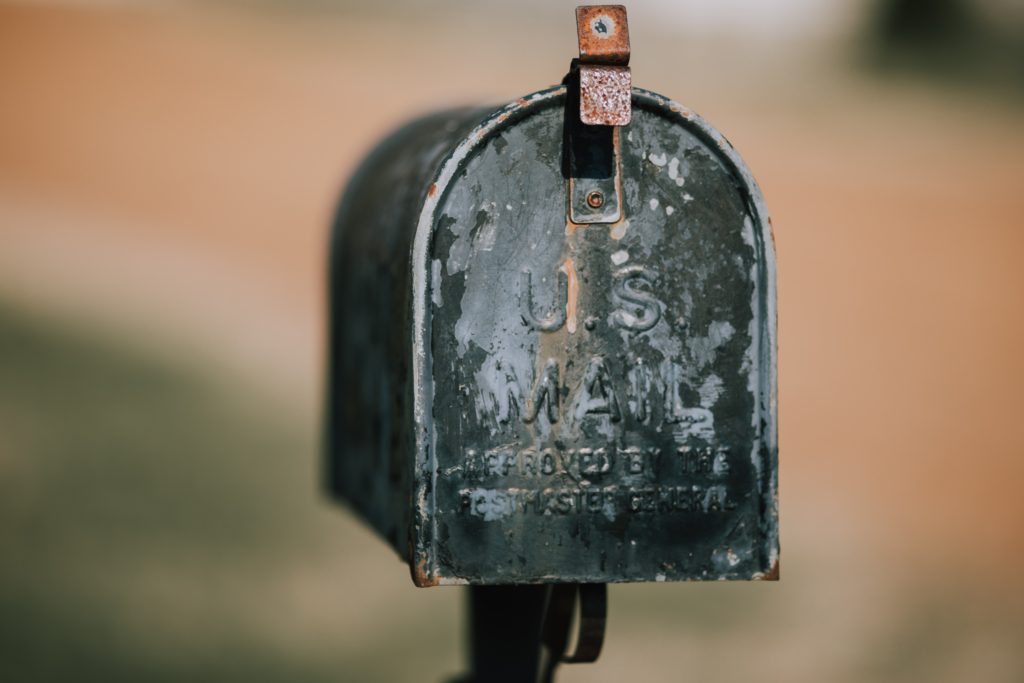 old weathered metal roadside mailbox