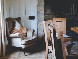 various chairs in a dim, stone room